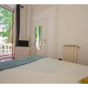 vista della stanza dal letto matrimoniale che punta sul balcone privato