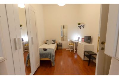 vista della stanza con letto singolo e armadio con specchio