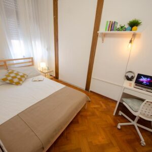 dettaglio della stanza con letto matrimoniale e scrivania per studio