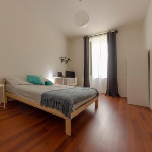 panoramica stanza con letto matrimoniale, zona studio e finestra